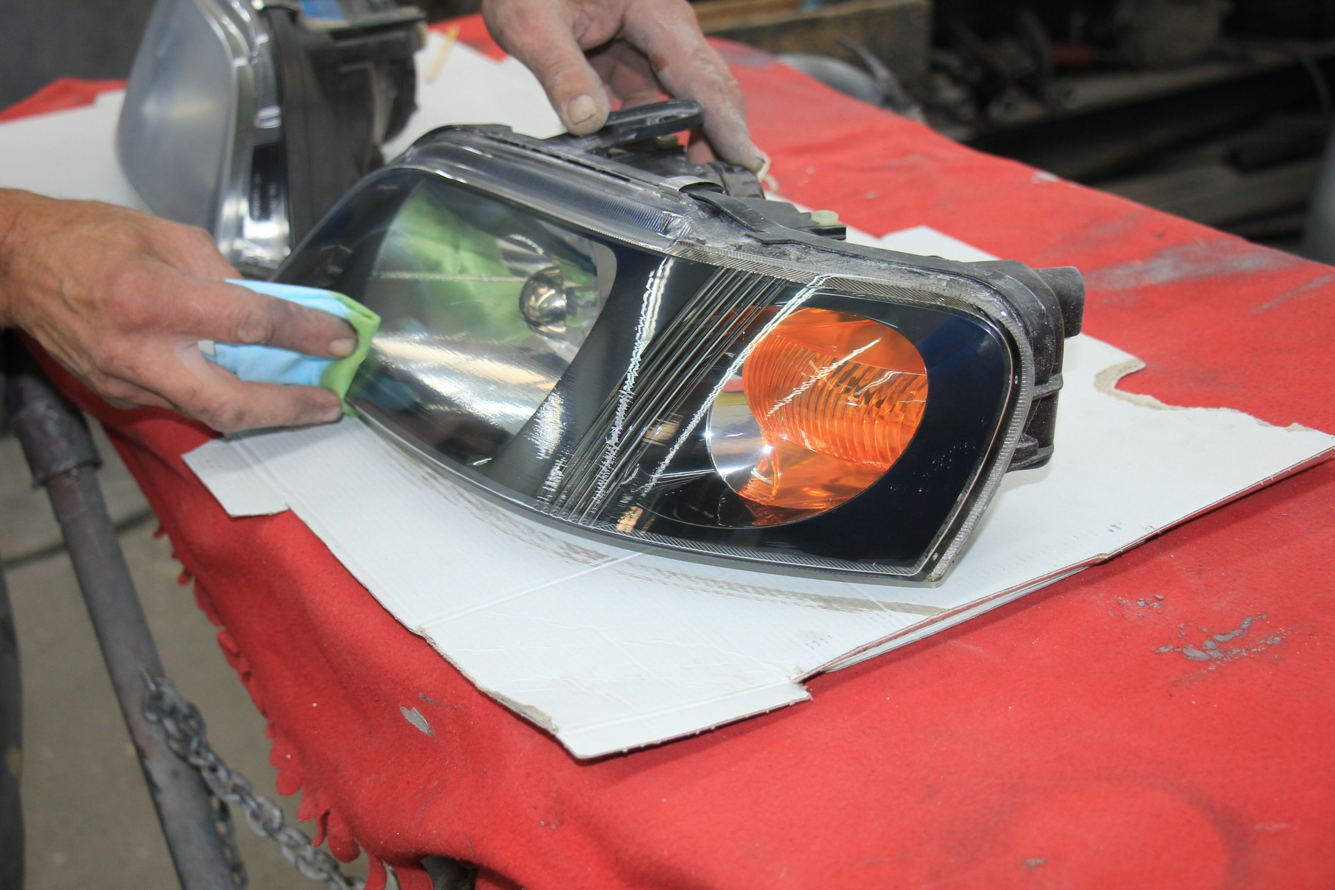 Man refurbishing car headlight